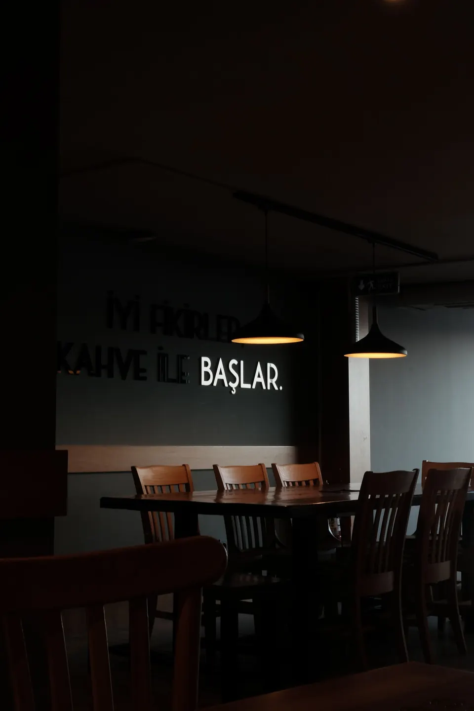 A dark, modern dining room set for evening service