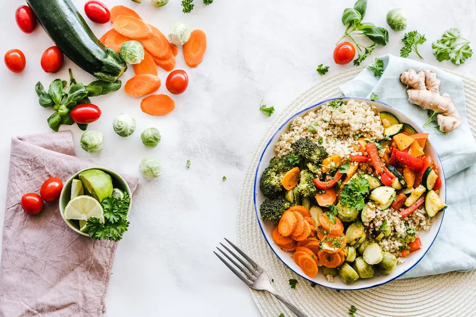 Colourful grain bowl surrounded by fresh produce, shot from above